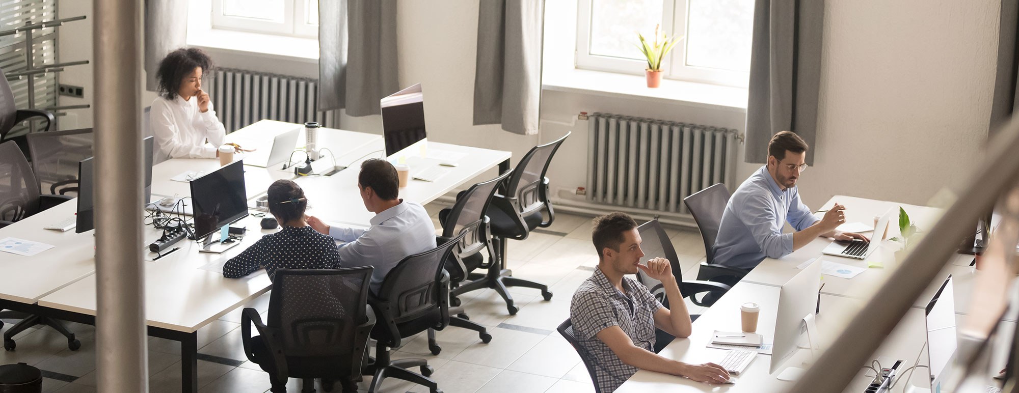 Image of an Open Office with people working at desks