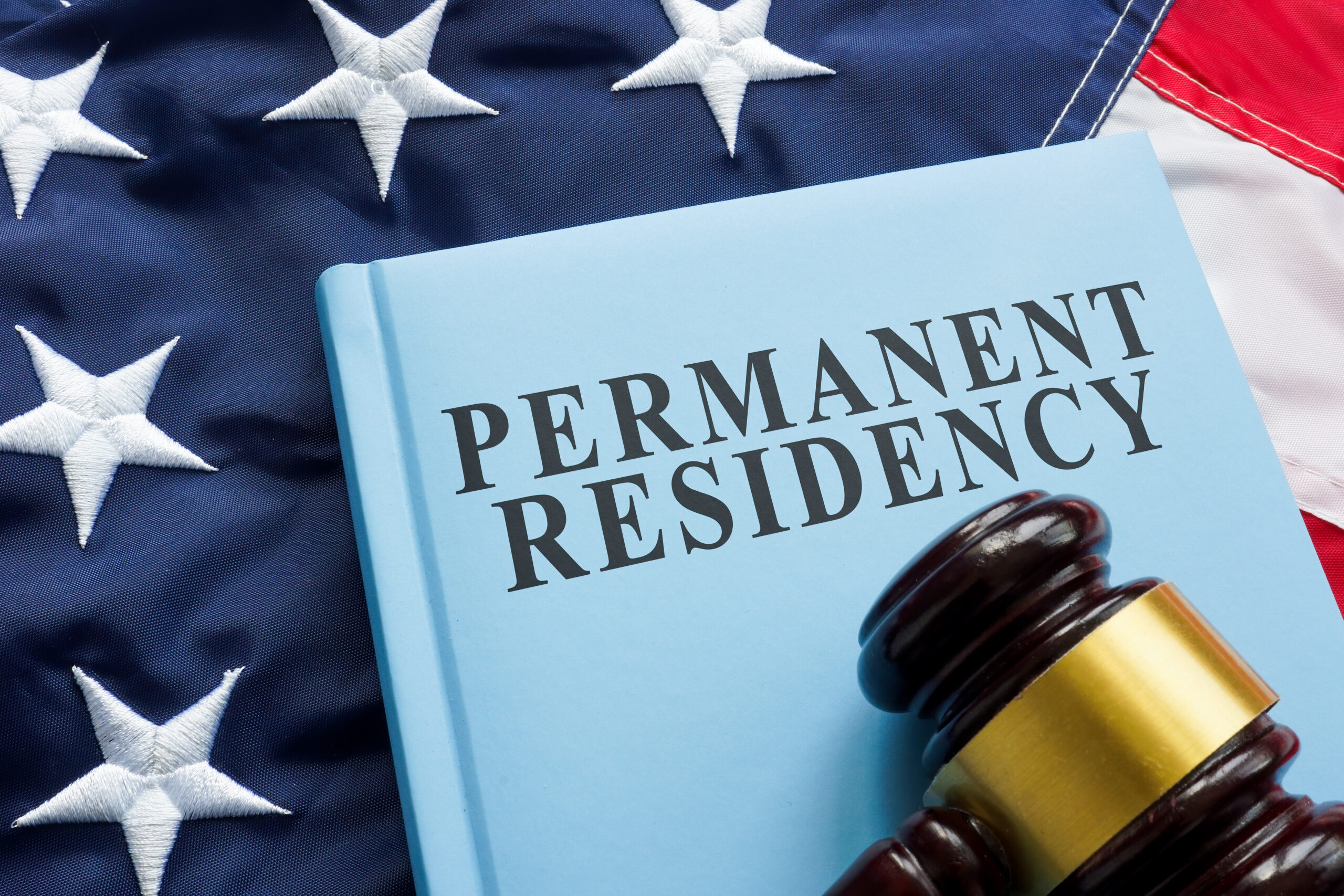 Permanent residency law book on the flag. image