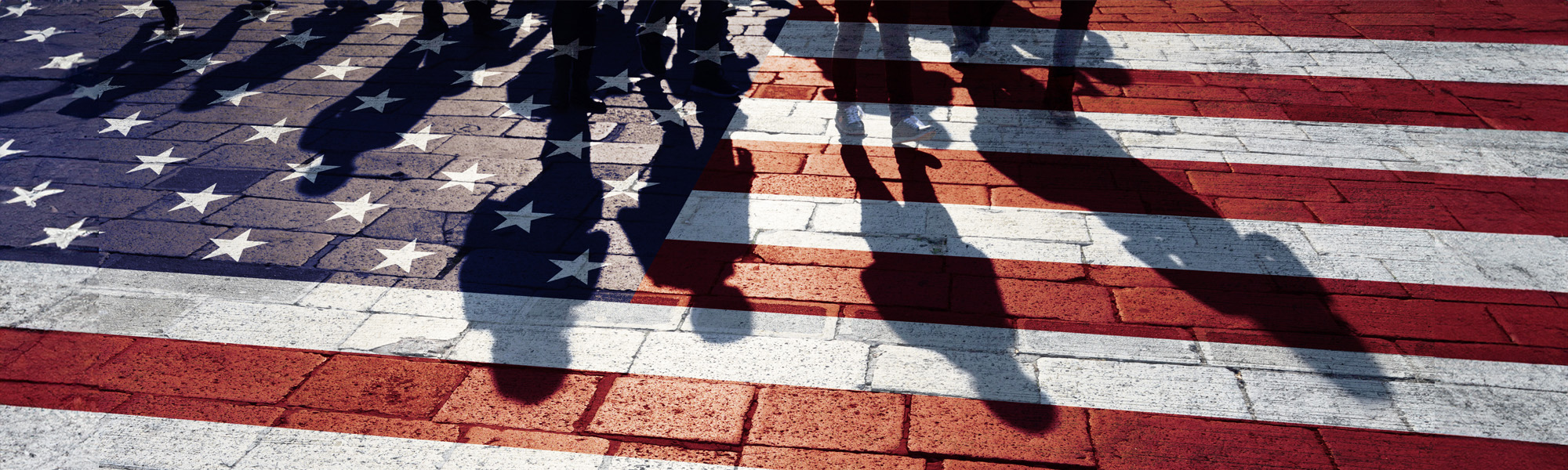 road painted with american flag and poeple silhouetted on it image