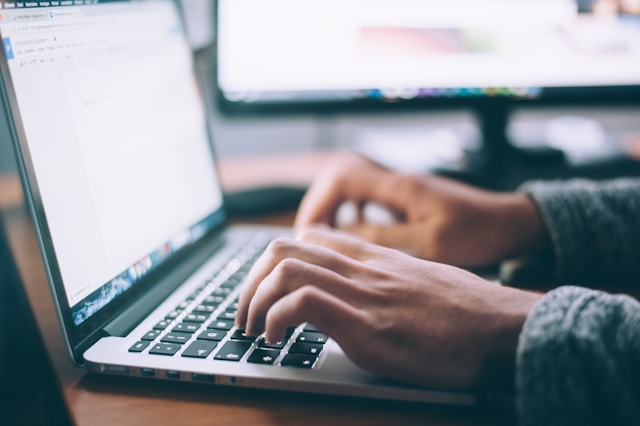 man typing on computer image