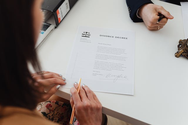 woman in front of divorce papers
