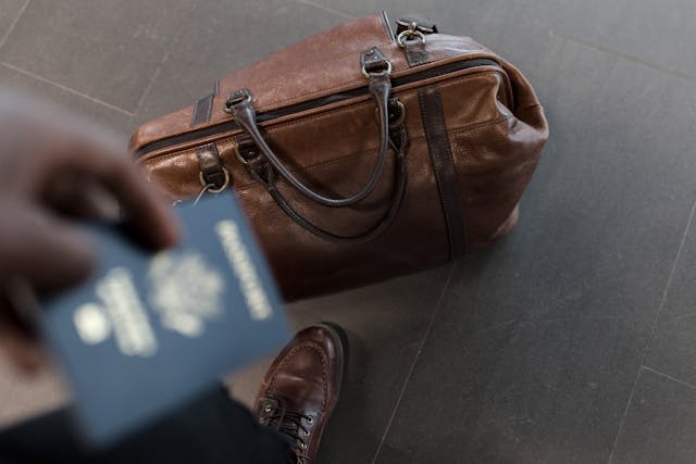 person with bag and passport