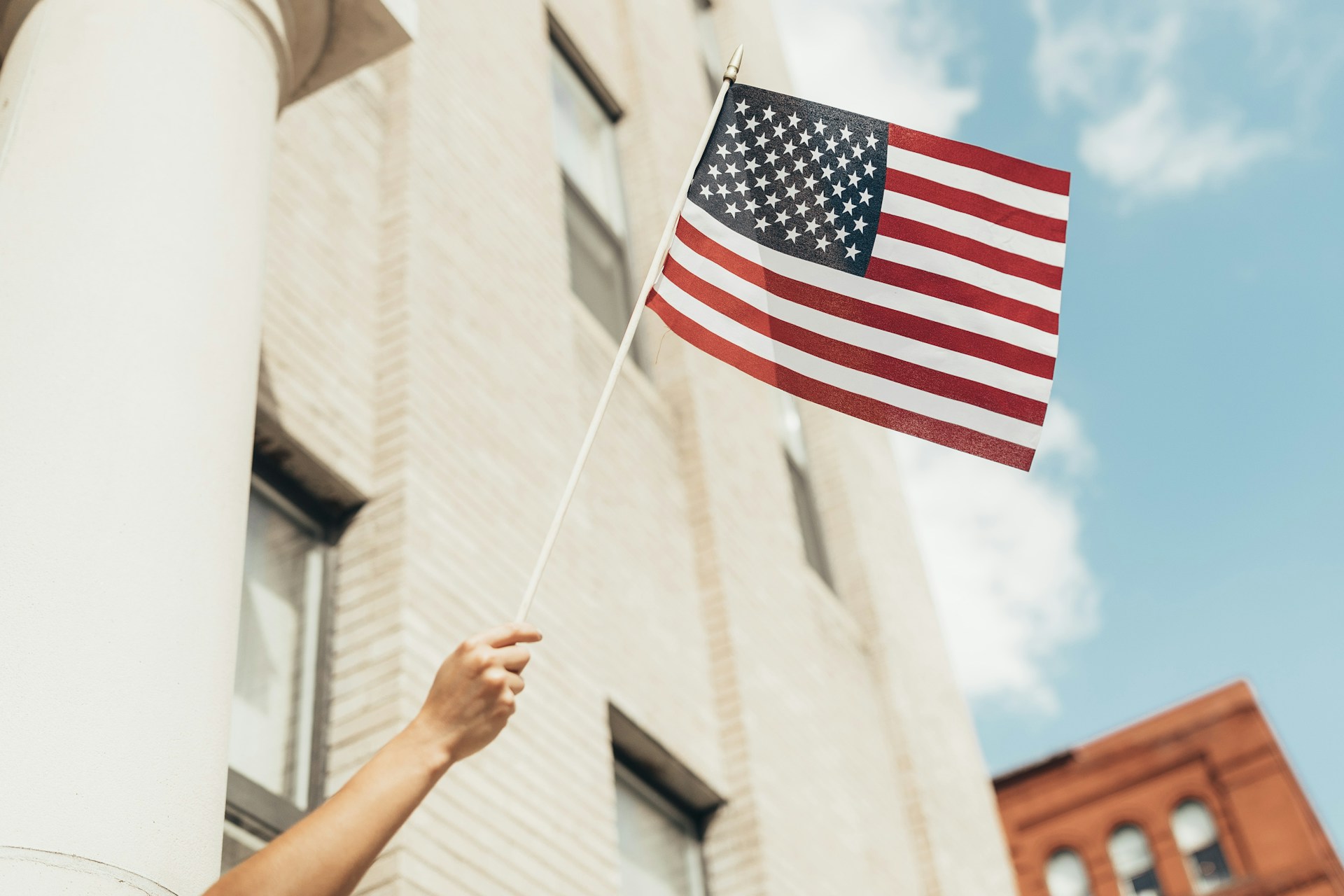 person waving American flag image