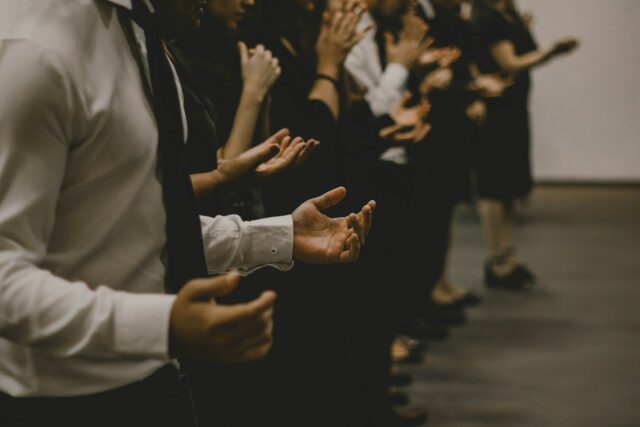 people with hands outstretched