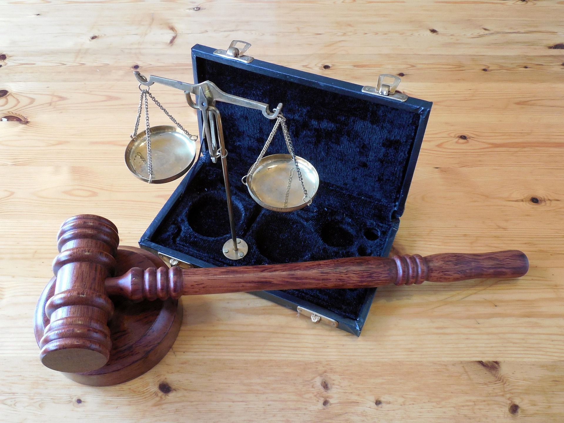 gavel in briefcase with scales of justice image