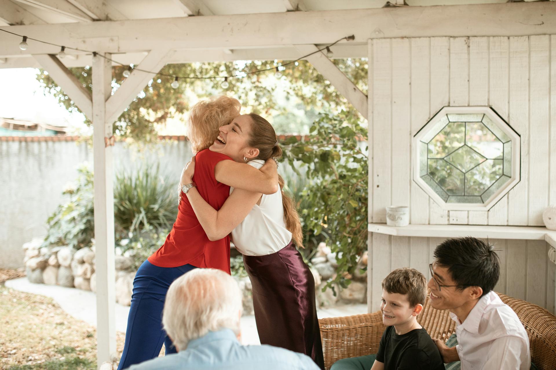 family smiling and hugging image